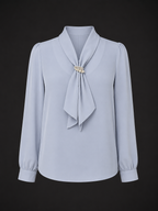 Light blue blouse with a tie detail on a black background