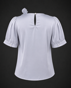Light blue blouse with puff sleeves on a black background