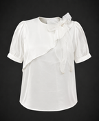 White blouse with floral details on a black background