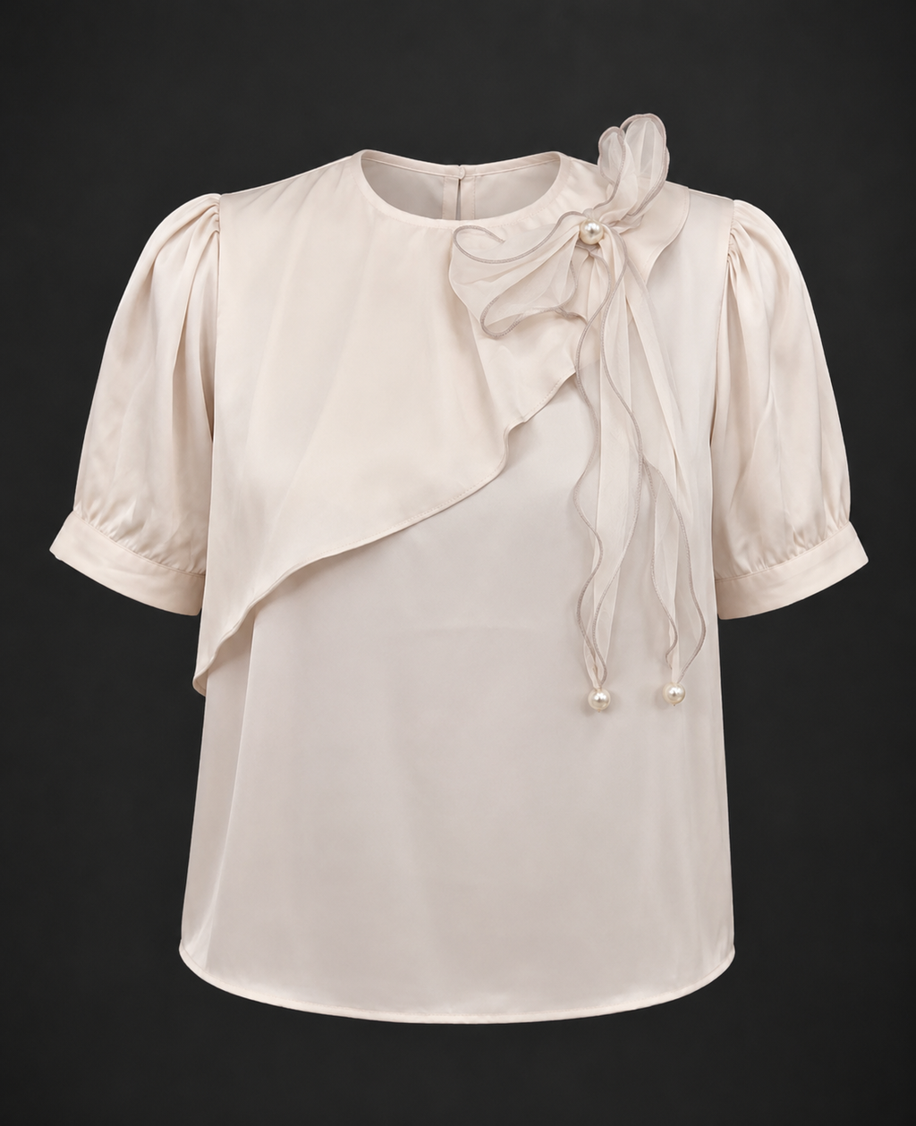 White blouse with ruffled sleeves and bow detail on a black background