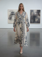 Woman wearing a long floral dress in an art gallery setting