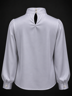Light gray blouse with puffed sleeves on a black background
