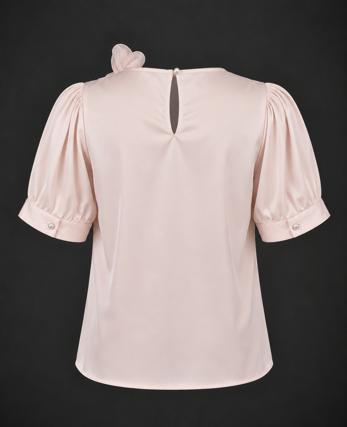 Pink blouse with puff sleeves on a black background