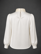 White blouse with long sleeves on a dark background