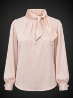 Pink blouse with a bow neckline on a black background