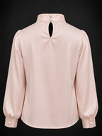 Pink blouse with long sleeves and a high collar on a black background