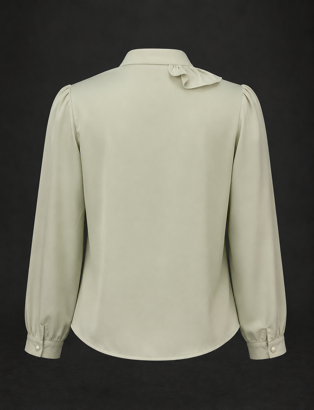 Light green blouse with long sleeves and a bow detail on a black background