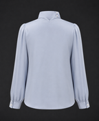 Light blue blouse with long sleeves on a black background