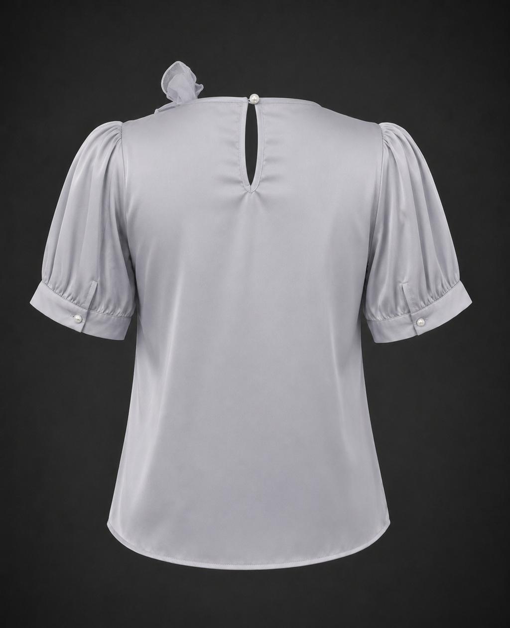 Light gray blouse with puff sleeves on a black background