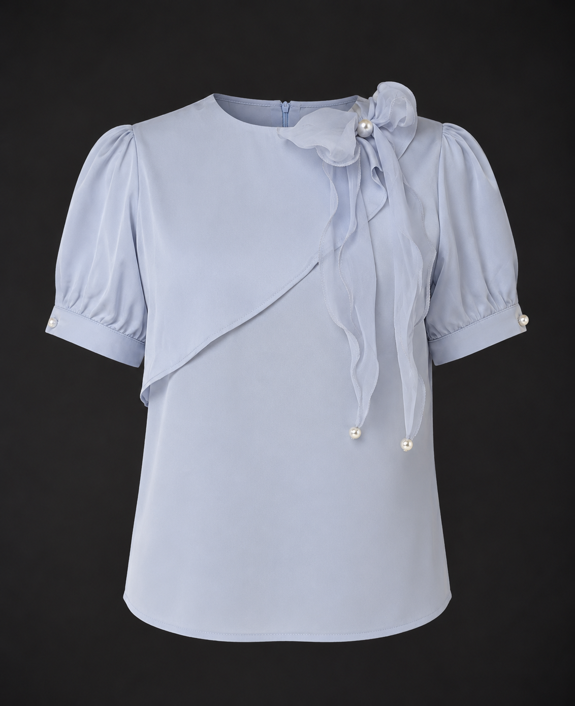 Light blue blouse with puff sleeves on a black background