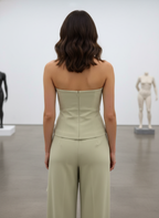 Woman wearing a strapless jumpsuit in an art gallery setting