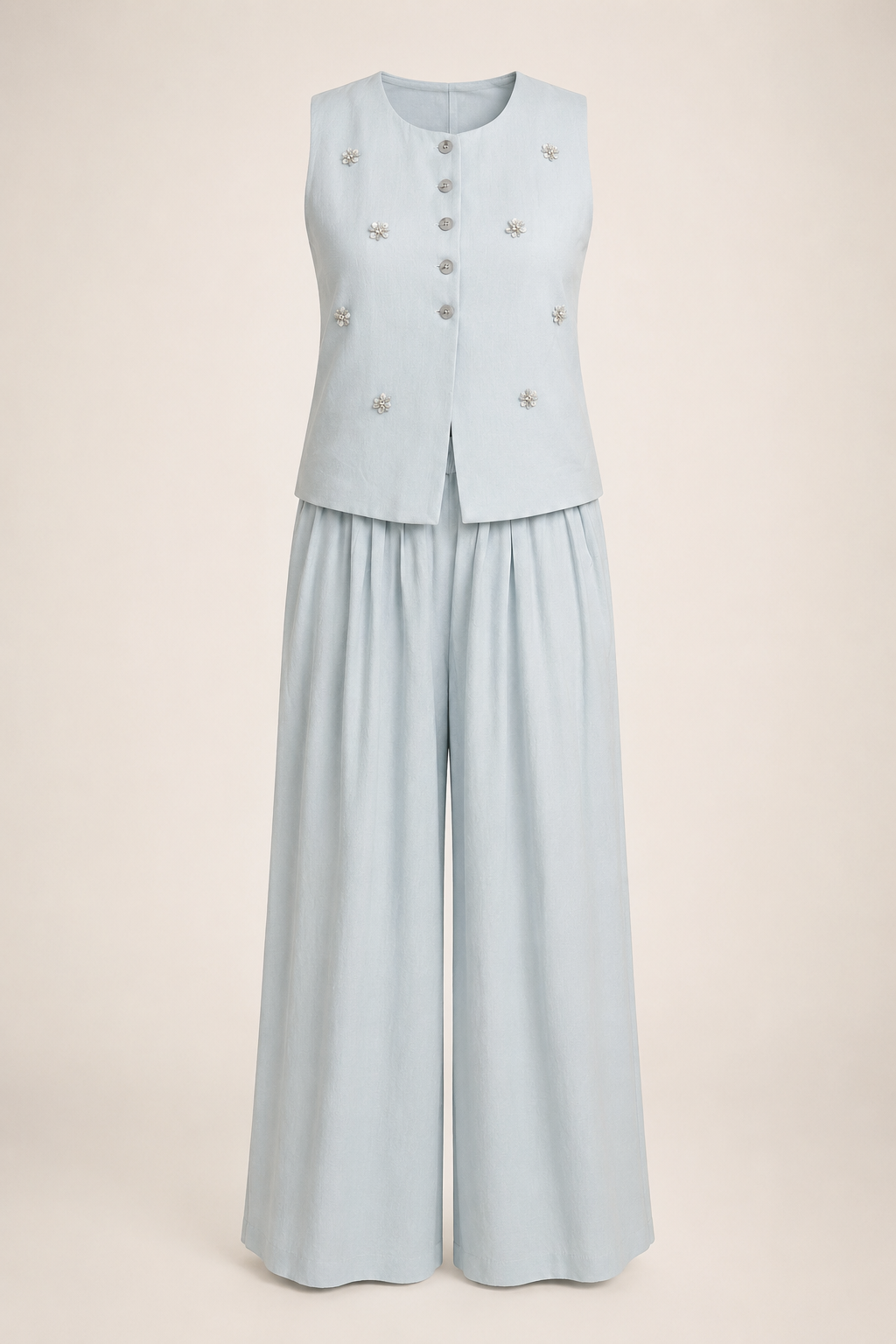 Light blue sleeveless top with buttons and wide-leg pants on a beige background