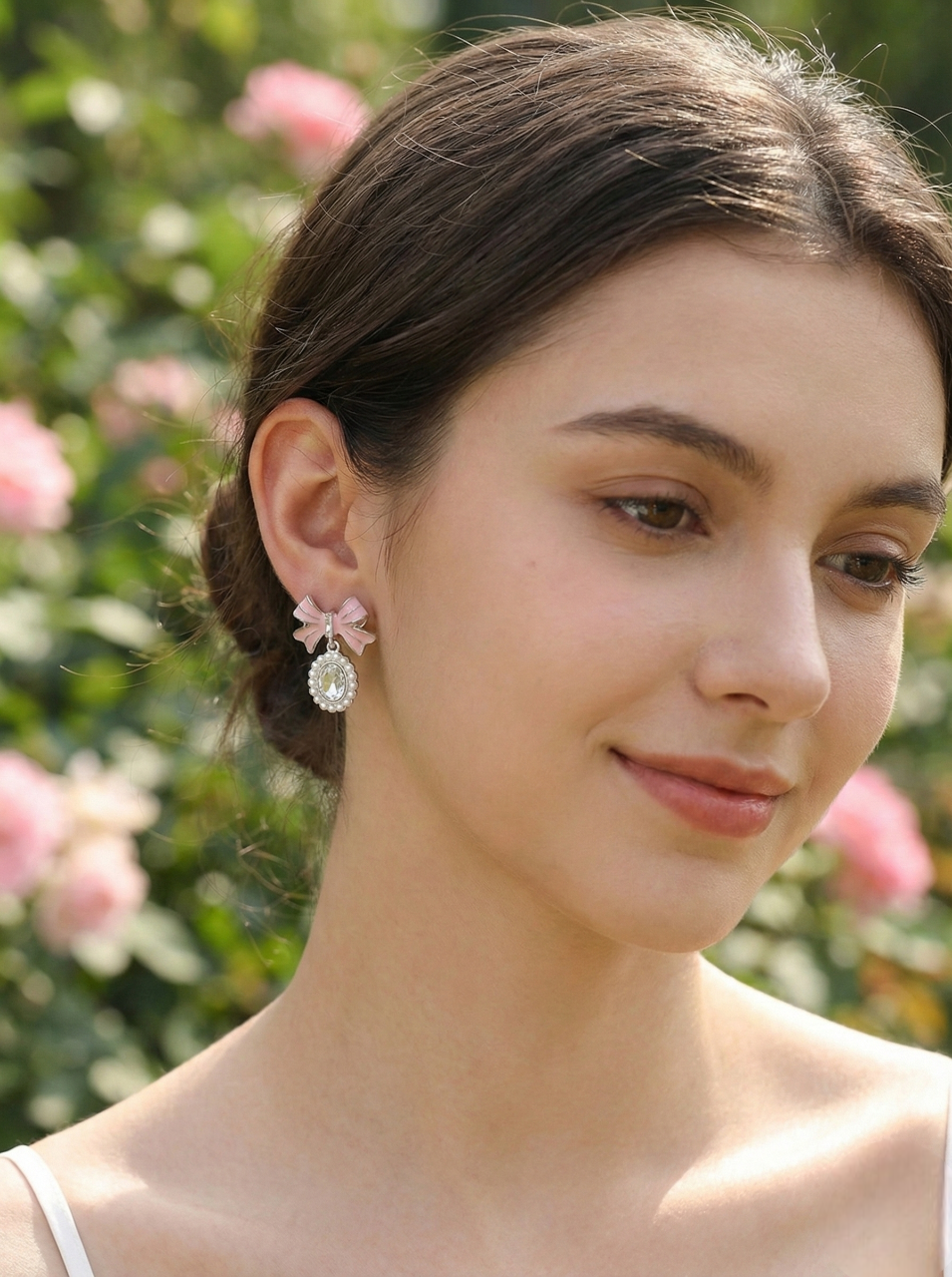 Woman wearing floral earrings with a blurred floral background