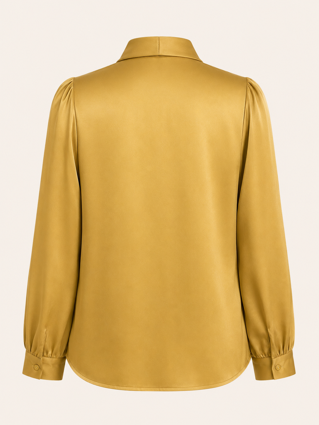 Yellow blouse with long sleeves on a light beige background