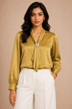 Woman wearing a mustard yellow blouse with a beige background