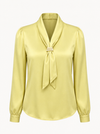 Yellow blouse with a tie neckline on a white background