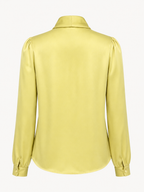 Yellow blouse with long sleeves on a white background