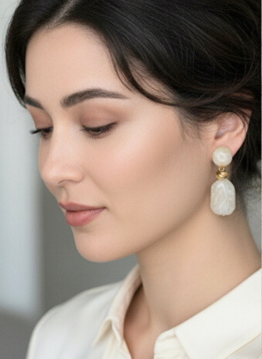 Close-up of a woman wearing elegant earrings with a blurred background