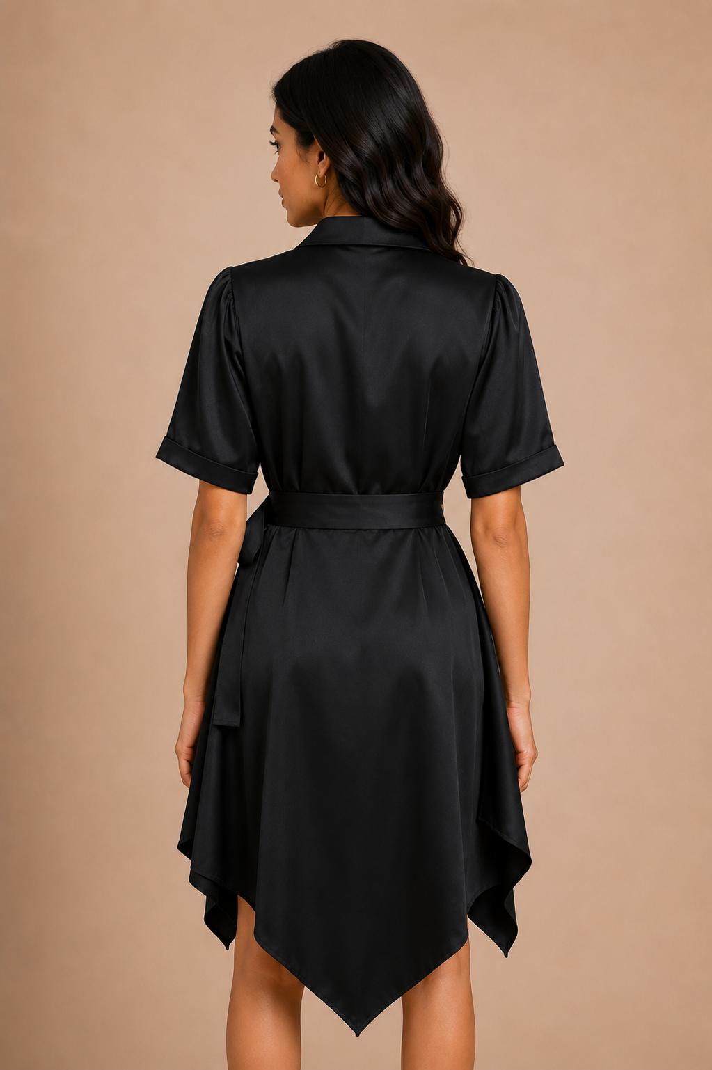 Woman wearing a black satin dress against a beige background
