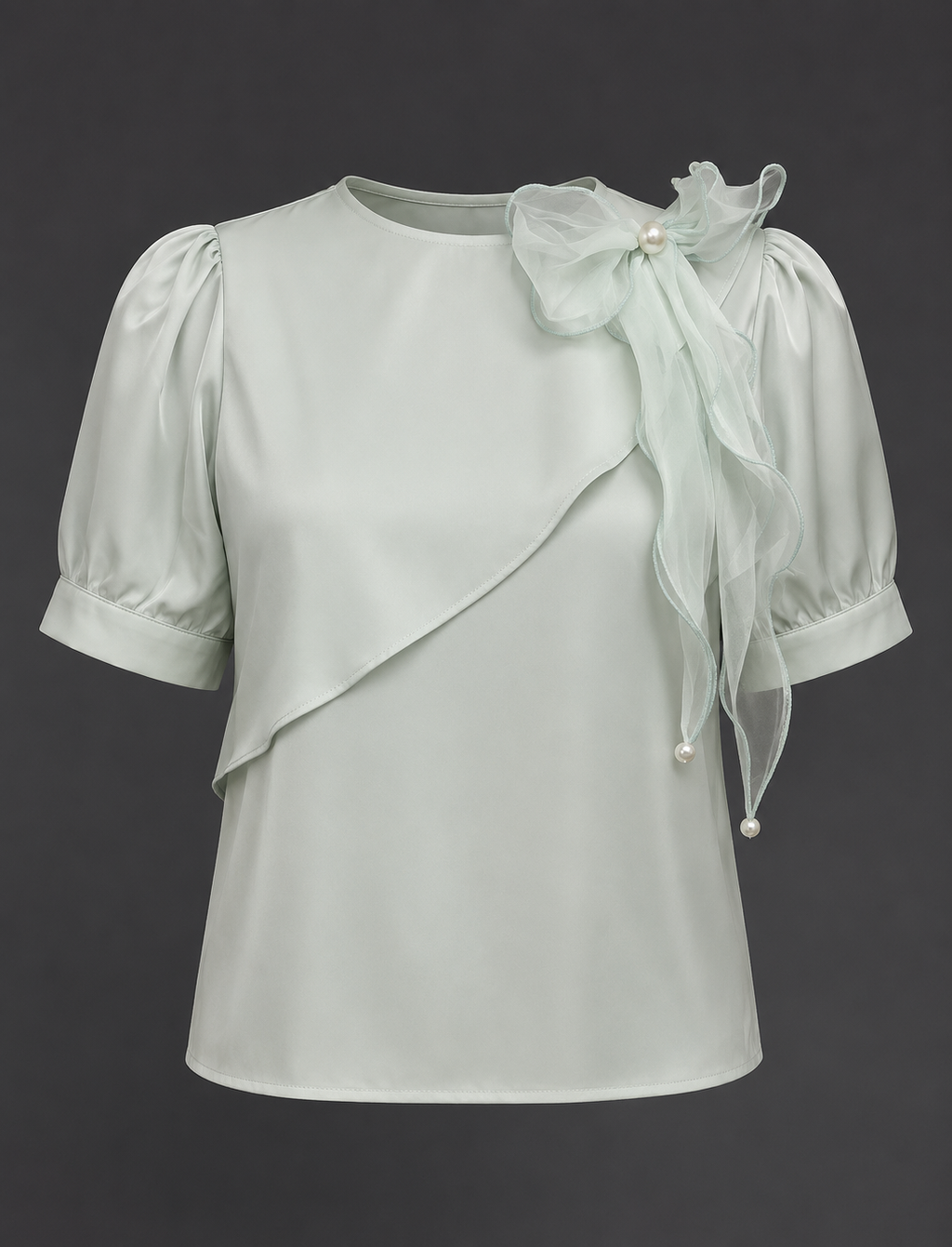 Light gray blouse with sheer sleeves and floral details on a dark background