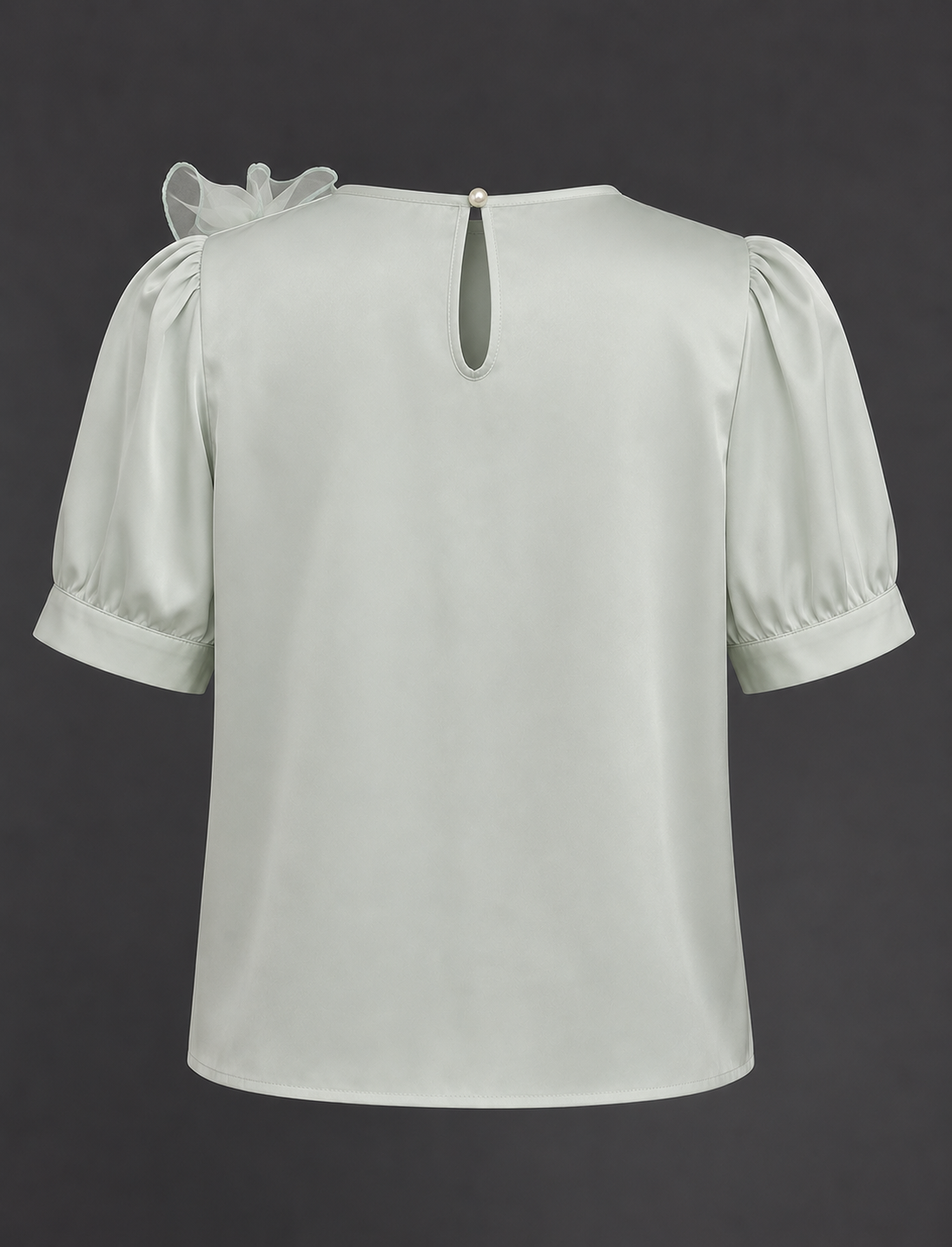 Light green blouse with puff sleeves on a dark background