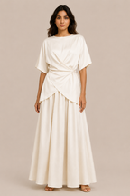 Woman wearing a white dress against a beige background