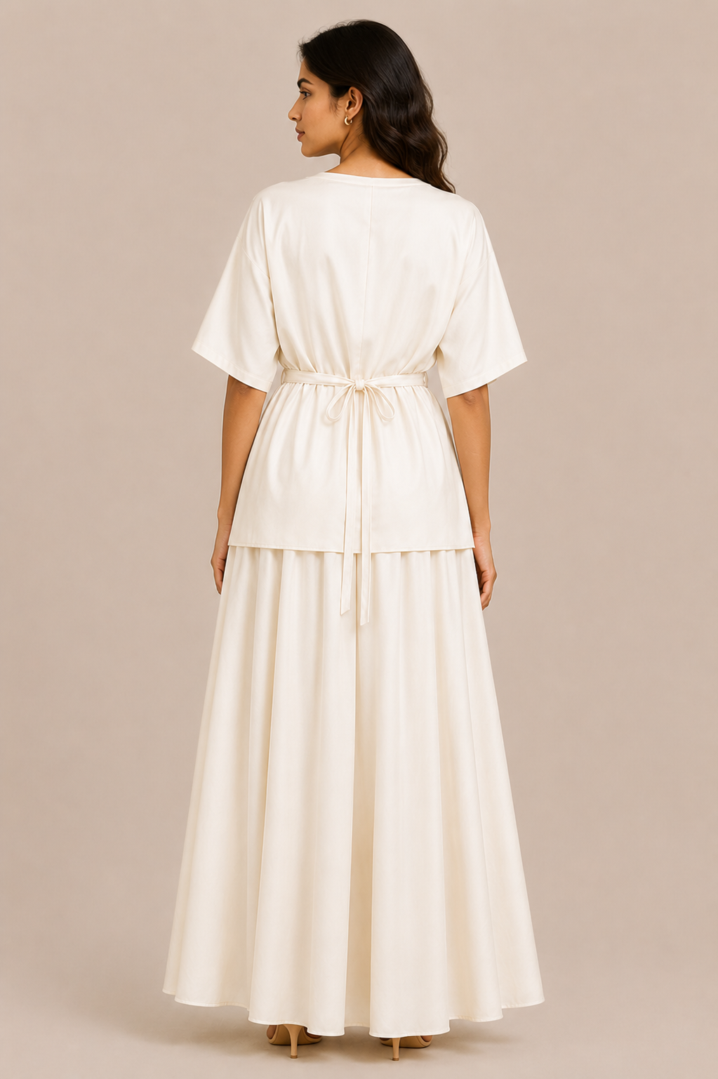 Woman wearing a white dress against a beige background