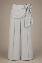 Light gray wide-leg pants with a tie waist on a beige background