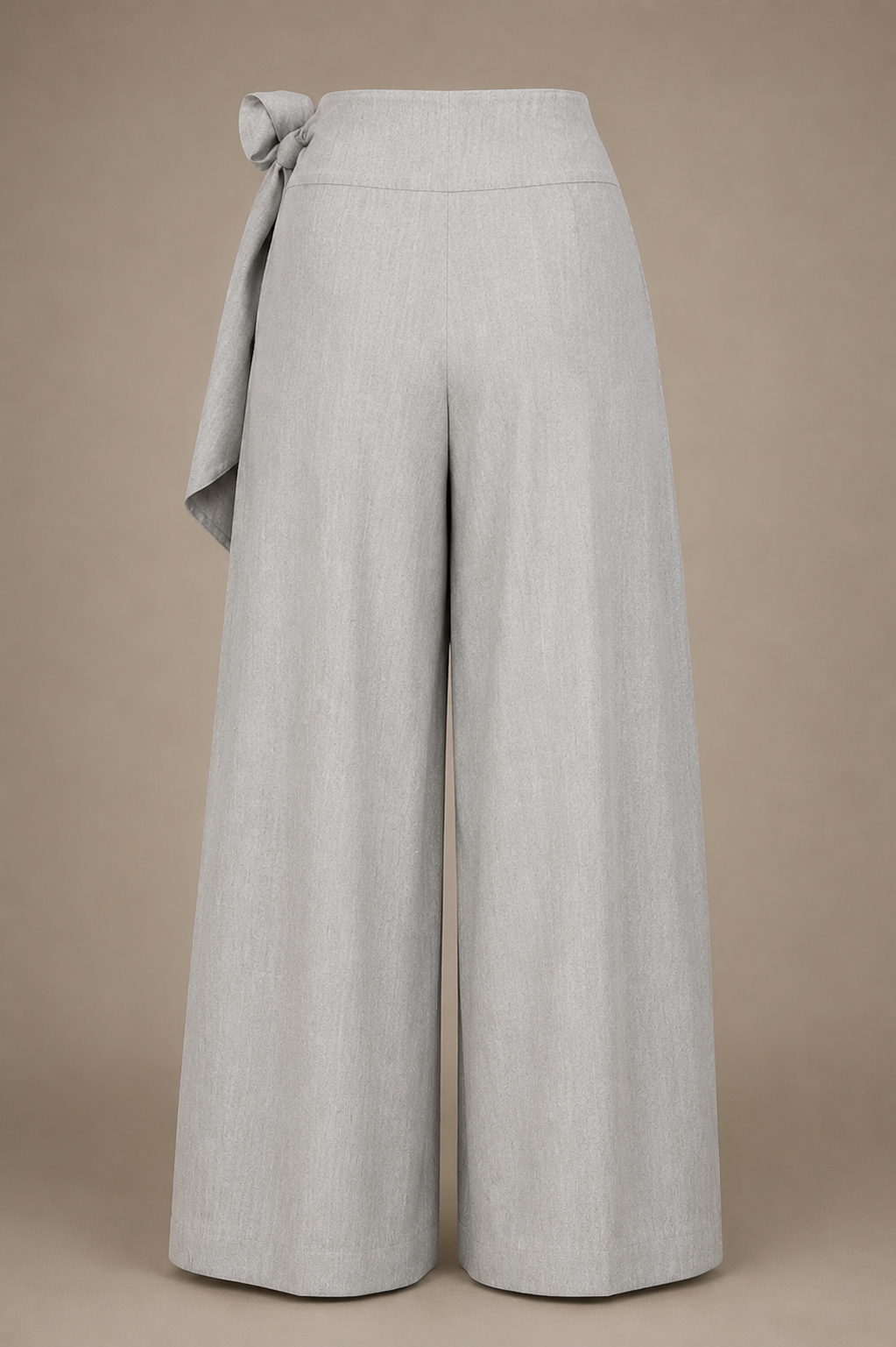 Light gray wide-leg pants with a tie waist on a beige background