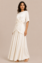 Woman wearing a white dress against a beige background
