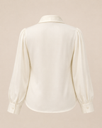 White blouse with long sleeves on a beige background