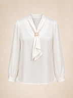 White blouse with a tie detail on a beige background