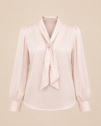 Light pink blouse with a tie detail on a beige background
