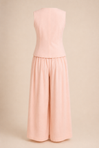 Pink sleeveless top and wide-leg pants set on a beige background