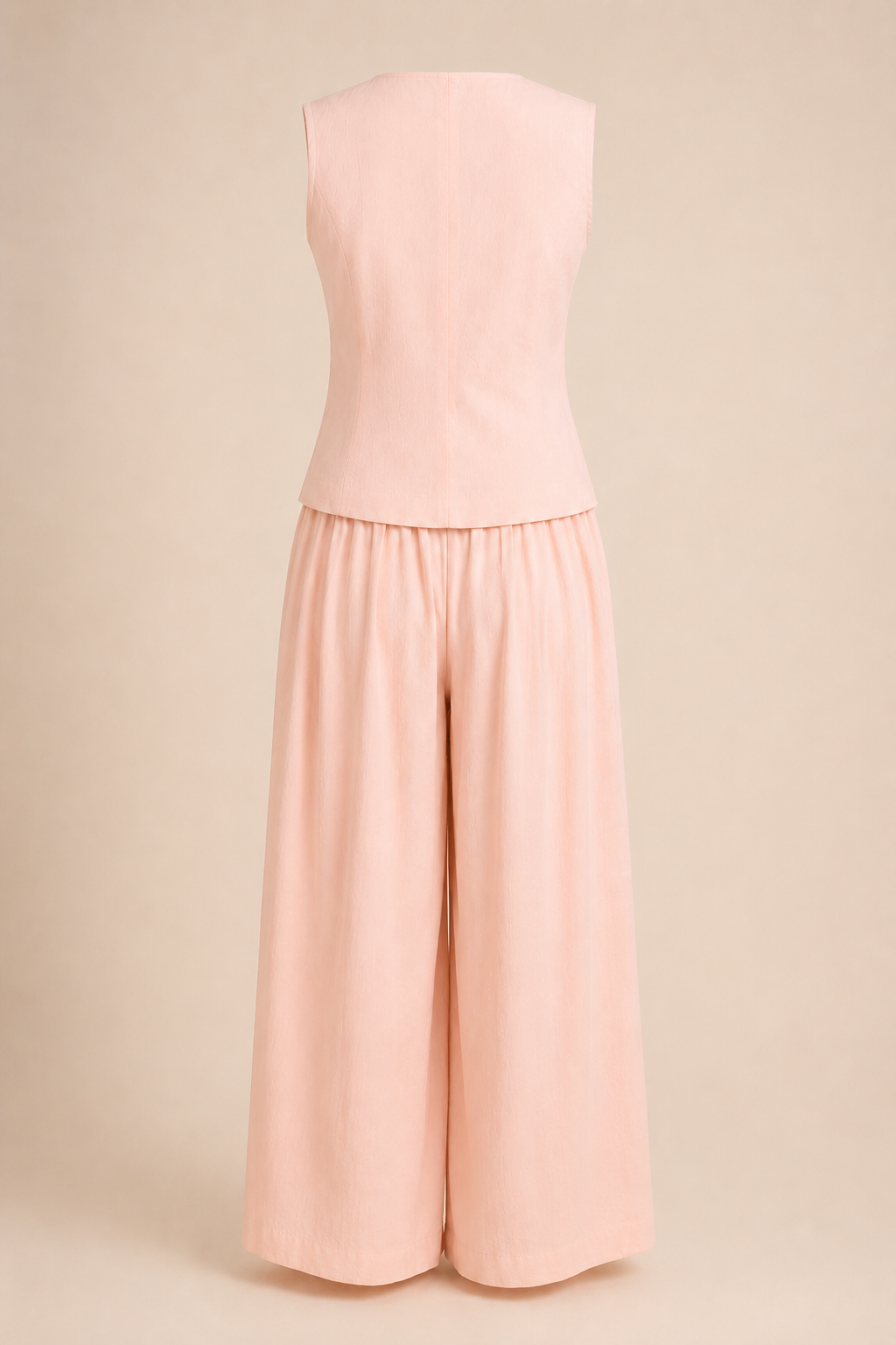 Pink sleeveless top and wide-leg pants set on a beige background