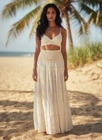 Woman in a white outfit standing on a beach with palm trees in the background