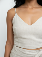 Light-colored top worn by a person against a neutral background